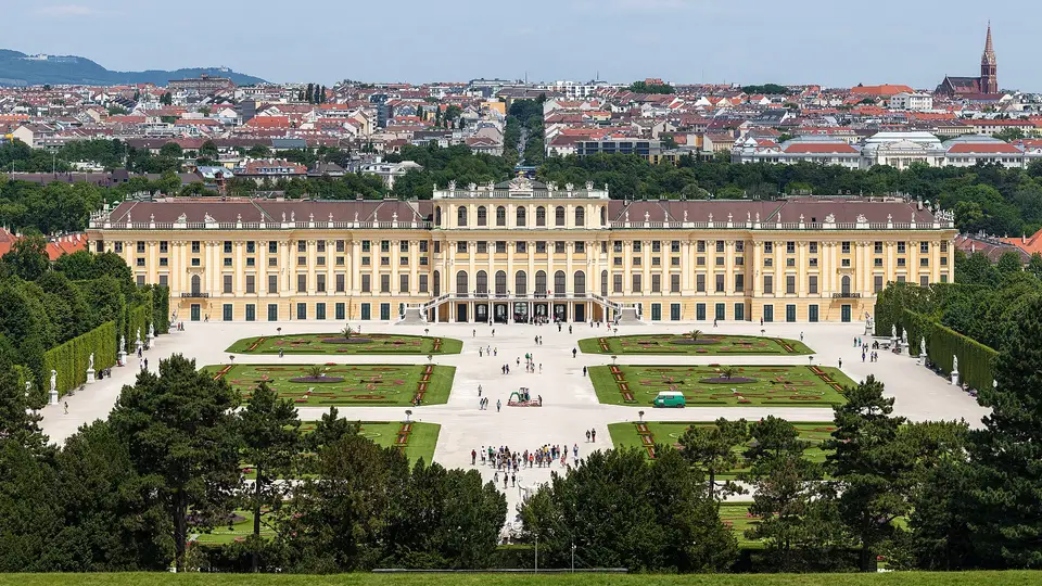 Schönbrunn Palace and its formal gardens seen from the hill, with the rooftops of Vienna beyond